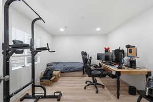 Office space featuring light wood-style flooring and recessed lighting