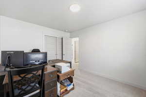Office area with light colored carpet and baseboards