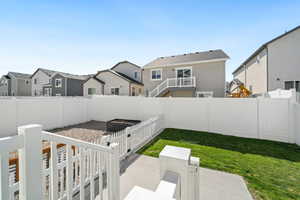 Fenced backyard with a residential view and a patio