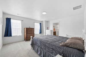 Carpeted bedroom featuring baseboards