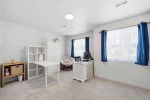 Home office featuring light colored carpet