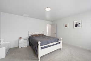 Carpeted bedroom with baseboards