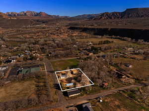 Overview of rural landscape with a mountain backdrop and property parcel outlined