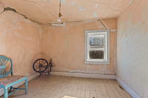 Spare room featuring hardwood / wood-style floors and baseboards