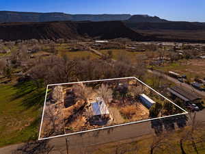 Aerial view of property's location with a mountainous background and property parcel outlined