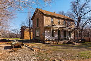 View of front of house with a porch and brick siding