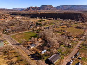 Aerial overview of property's location with a mountain backdrop and rural landscape