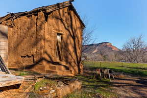View of side of property featuring a mountain view and an outbuilding