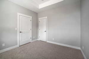 Unfurnished bedroom with baseboards and carpet floors