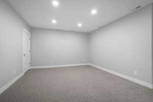 Spare room with light carpet and recessed lighting