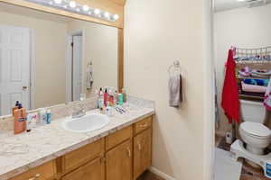 Bathroom featuring vanity and toilet