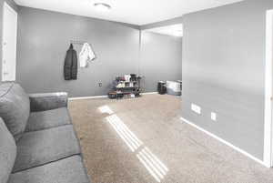 Carpeted living room featuring baseboards