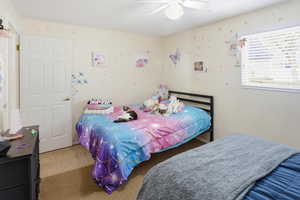 Carpeted bedroom with ceiling fan