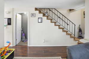 Stairway featuring wood finished floors and baseboards