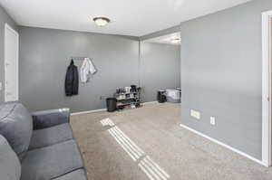 Living room with carpet floors and baseboards
