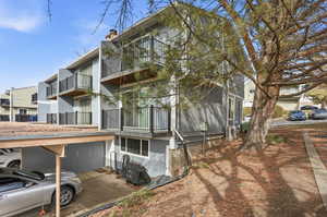 Rear view of house featuring a chimney and a balcony
