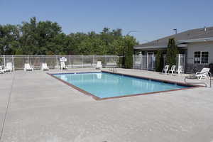 Community pool with a patio