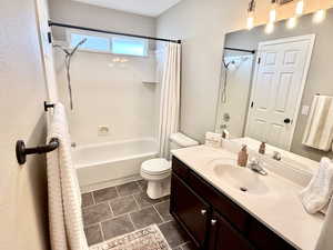 Bathroom with vanity and shower / tub combo with curtain