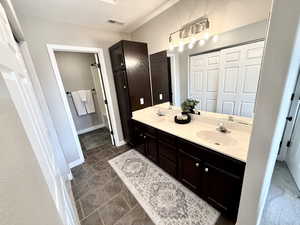 Full bath featuring double vanity and baseboards