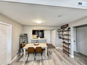 Dining space featuring baseboards and light wood-style floors
