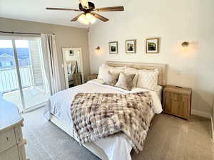 Bedroom with access to outside, carpet flooring, and a ceiling fan