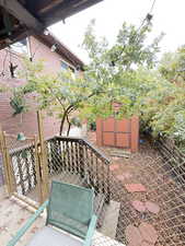 View of patio featuring a storage shed