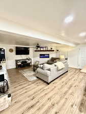 Living area with light wood-style flooring and recessed lighting