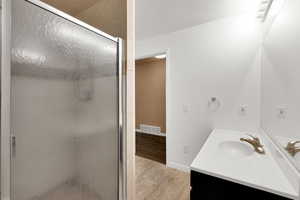 Full bathroom featuring vanity and a stall shower