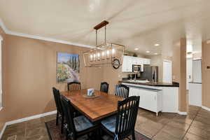 Dining room with a chandelier and recessed lighting
