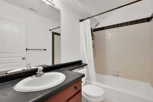 Bathroom featuring vanity and shower / tub combo