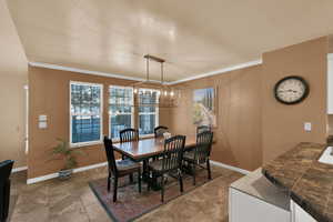 Dining room featuring baseboards and crown molding