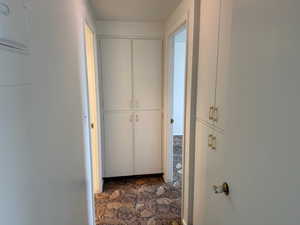 Hallway to bdrm with storage cupboards