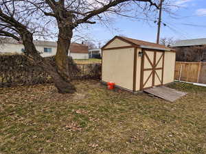 View of shed with a fenced backyard