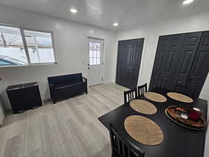 Dining space with light wood-type flooring and recessed lighting