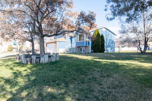 View of front of house with newer siding, concrete driveway, and a 2 car garage with a large yard.