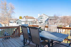 Deck with a residential view and outdoor dining area.