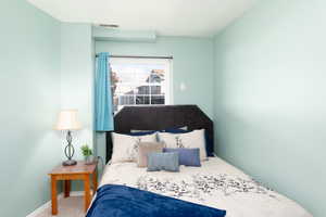 Basement bedroom with above grade windows, and carpet.