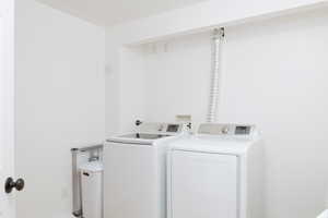 Large laundry room featuring washer and clothes dryer.