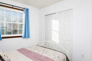 Bedroom featuring carpet flooring and baseboards.