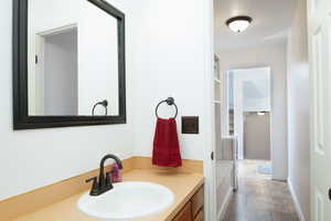 Half bathroom featuring vanity and toilet.