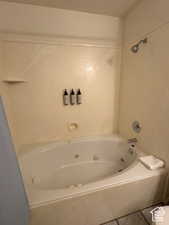 Bathroom featuring a combined bath / shower with jetted tub