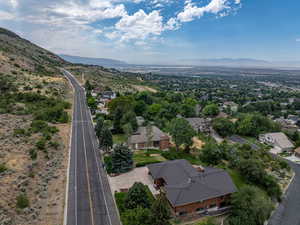 Aerial overview of property's location featuring a mountain backdrop and nearby suburban area