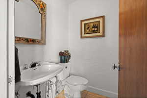 Bathroom with a textured wall and tile patterned flooring