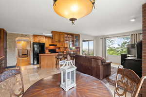 Dining area featuring arched walkways and light tile patterned floors