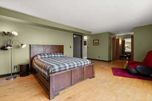 Bedroom with light wood-style floors and baseboards