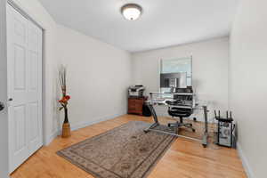 Home office with light wood-style flooring