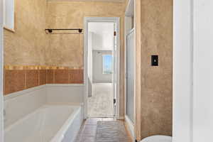 Full bathroom with a garden tub, a stall shower, and light tile patterned floors