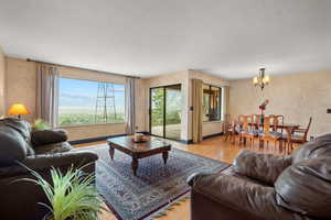 Living area featuring light wood-style floors and a chandelier