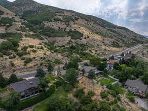 Aerial view of property and surrounding area with a mountain backdrop