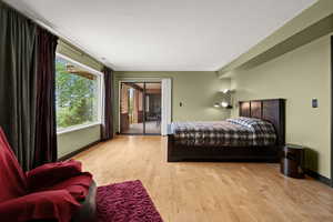 Bedroom with access to exterior and light wood-type flooring
